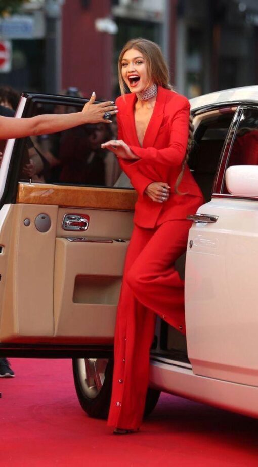 Dakota Johnson Or Gigi Hadid: Who Is The Attractive Diva In A Red Pantsuit? - 1