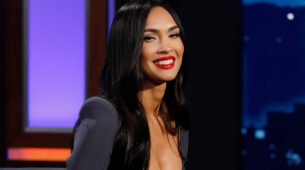 Megan Fox looks steaming hot in a black crop top, a blue mini skirt, and a coat