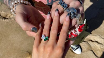Megan Fox showing off her diamond-emerald engagement ring by MGK