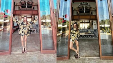 Malaika Arora looks gorgeous in a black and gold Versace Print silk pajama shirt