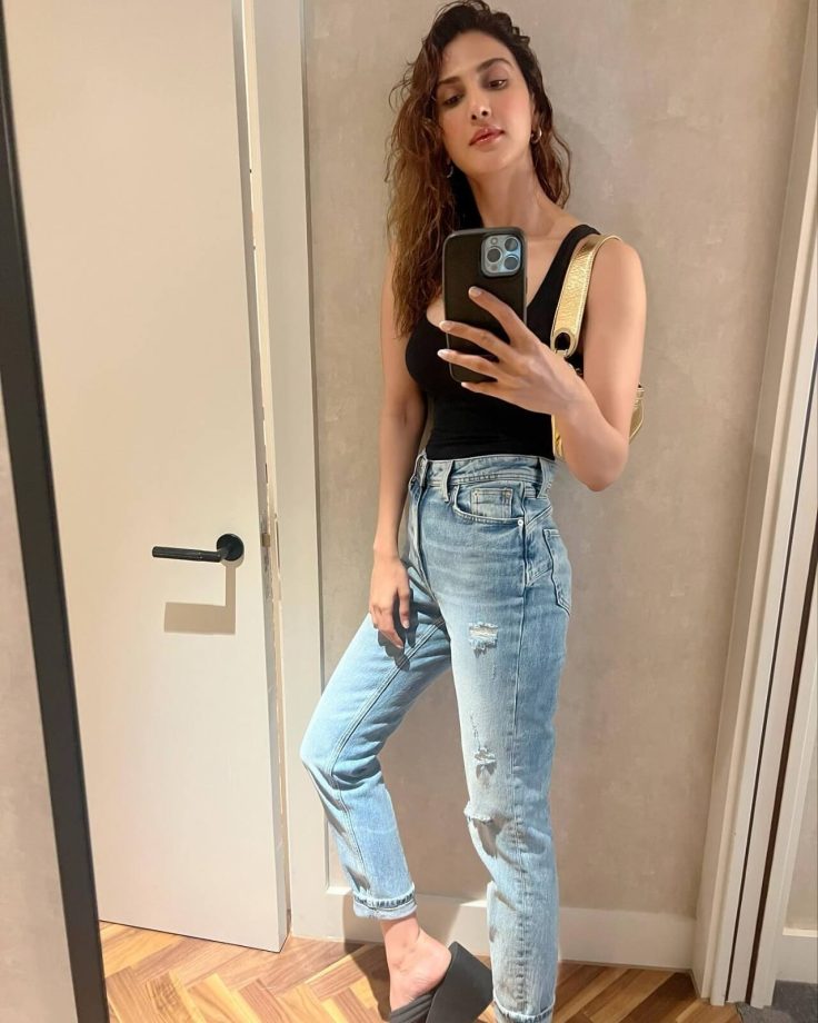 In Photos: Vaani Kapoor Spreads Casual Charm In Black Low Neckline Top And Ripped Denim 850186